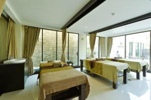 a room with three beds and a large window at Kacha Resort & Spa, Koh Chang in Ko Chang
