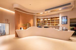 a restaurant with a large white counter in a room at Cheng Jin Hotel in Huangshan Scenic Area