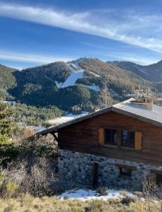 a log cabin with a view of a mountain at Chalet Ameo in Valdeblore