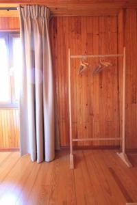 a room with a curtain and a wooden wall at Chalet Ameo in Valdeblore