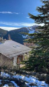 a house sitting on top of a snow covered mountain at Chalet Ameo in Valdeblore