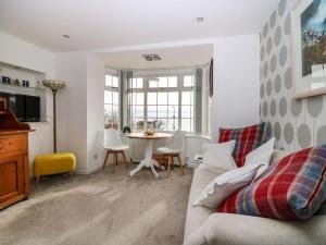 a living room with a couch and a table at Beach Cottage in Kinghorn