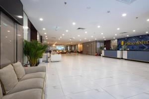 a lobby with couches in the middle of a building at Virgo Hotel Nha Trang in Nha Trang