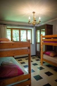 a bedroom with two bunk beds and a chandelier at La Roseraie in Lodève