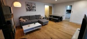 a living room with a couch and a piano at Maison au calme avec terrasse, climatisé in Vertaizon