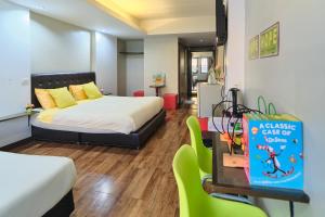 a bedroom with a bed and a table and chairs at Bkk39 Airport hotel in Ban Khlong Prawet