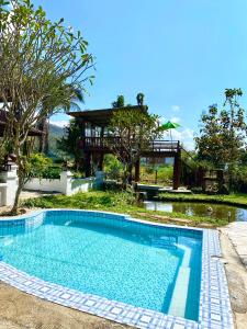 a swimming pool in front of a house at Shaya Suandoi Resort in Pai