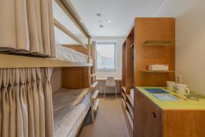 a dorm room with bunk beds and a desk at Mangrove Dongdaemun in Seoul