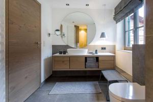 a bathroom with a sink and a mirror at Fügenschuhs Genussferien in Bad Hindelang