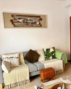 a living room with a couch and a chair at Piles Playa Beach Apartment in Piles