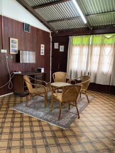 a room with chairs and a table and a desk at Homestay 4 minit ke Jeti Pulau Kapas Marang tingkat atas in Marang