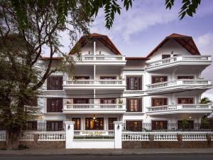 a large white building with balconies at Chateau d'Angkor La Residence in Siem Reap