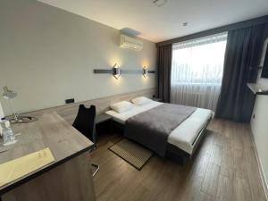 a hotel room with a bed and a desk at Hotel Complex Ukraine in Lutsk