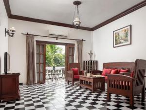 a living room with a couch and a table at Chateau d'Angkor La Residence in Siem Reap