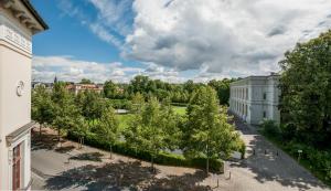 an aerial view of a building with trees and a field at Dorint Am Goethepark Weimar in Weimar