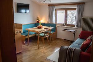 a living room with a table and a couch at Wohnung mit Bergblick im Haus Sonne in Reith bei Seefeld