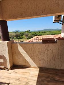 a balcony with a view of a roof at Tlokweng Rose Garden Guesthouse in Gaborone
