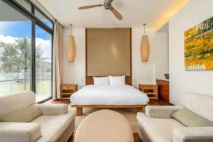 a bedroom with a bed and a large window at Villa seaview and apartment Da Nang by JT group in Da Nang