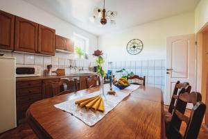 a kitchen with a wooden table in a kitchen at Grandma's apartment in Velika