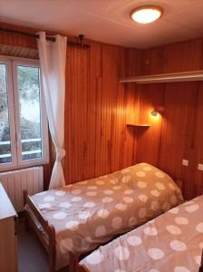 a bedroom with two beds and a window at 2 pièces proche cure thermale in Roquebillière