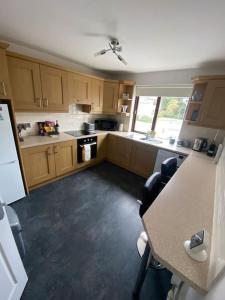 a kitchen with wooden cabinets and a table with chairs at The Courtyard in Newcastle