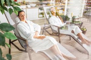 two women sitting in chairs in a salon at Life Hotel 4 Superior in Bibione +157 photos