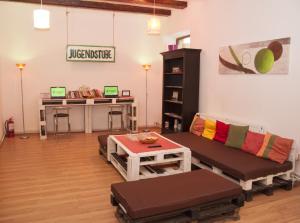 a living room with a couch and a table at JugendStube Hostel in Braşov