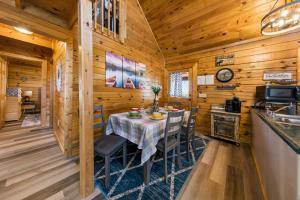 a dining room with a table in a log cabin at Serenity, A Rustic Log Cabin Retreat in Sevierville