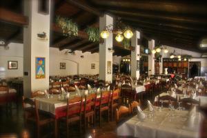 a dining room with tables and chairs with white tablecloths at Hotel Ciocca in Castelnuovo Don Bosco