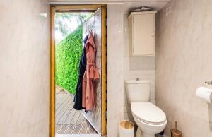 a bathroom with a toilet and a picture on the door at The hideaway in Bristol