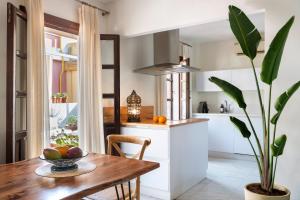 a kitchen with a wooden table and a potted plant at MonKeys Apartments Alameda House in Seville
