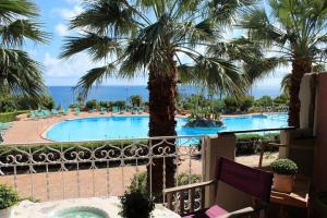 a view from the balcony of a resort with a swimming pool at Rais Gerbi Appartamento in Pollina