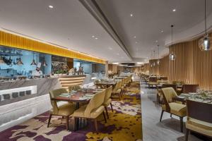 a restaurant with tables and chairs and a bar at The QUBE Hotel Shanghai Hongqiao in Shanghai