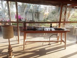 a wooden table in front of a window at Le Bunker, design apartment in Dakar