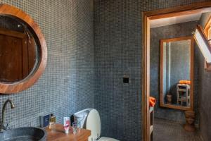a bathroom with a sink and a toilet and a mirror at Le Bunker, design apartment in Dakar