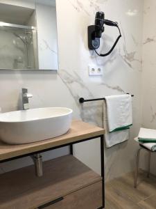 een badkamer met een witte wastafel en een spiegel bij Hotel Villa México 