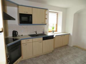 a kitchen with a sink and a microwave at Monteurzimmer in Dresden