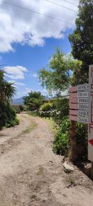 a sign that is next to a dirt road at Rusthof Accommodation in Gansbaai