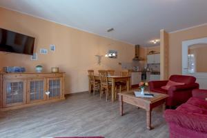 a living room with a couch and a table at Villa-Senta-Apartment-1 in Kühlungsborn