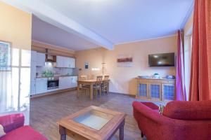 a living room with a table and a kitchen at Villa-Senta-Apartment-3 in Kühlungsborn