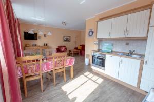 a kitchen and dining room with a table and chairs at Villa-Senta-Apartment-8 in Kühlungsborn