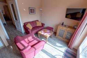 a living room with two chairs and a table at Villa-Senta-Apartment-9 in Kühlungsborn