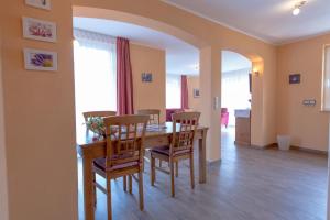 a dining room with a wooden table and chairs at Villa-Senta-Apartment-11 in Kühlungsborn