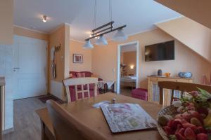 a living room and dining room with a table at Villa-Senta-Apartment-13 in Kühlungsborn