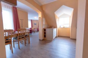 a dining room and living room with a table and chairs at Villa-Senta-Apartment-15 in Kühlungsborn +23 photos
