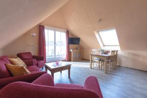 a living room with a couch and a table at Villa-Senta-Apartment-16 in Kühlungsborn