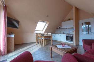 a living room with a couch and a table at Villa-Senta-Apartment-16 in Kühlungsborn