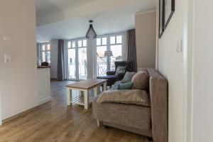 a living room with a couch and a table at Sunnevelt-Apartment-10 in Kühlungsborn