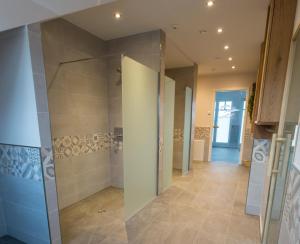 a bathroom with a walk in shower and a glass door at Sunnevelt-Apartment-10 in Kühlungsborn +23 photos