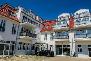a car parked in front of a building at Sunnevelt-Apartment-18 in Kühlungsborn